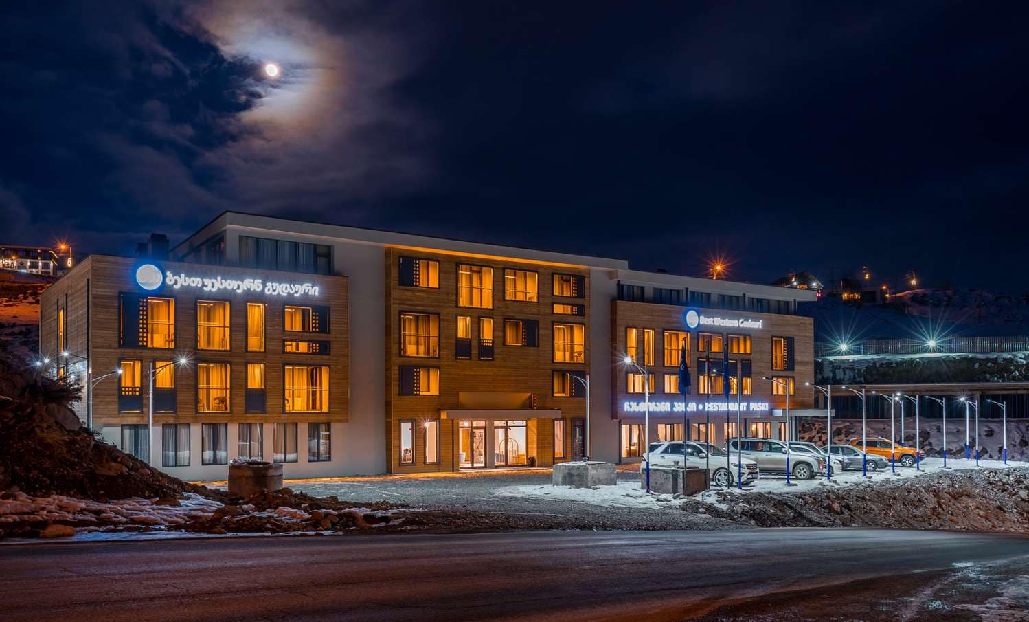 Best Western Gudauri hotel glowing at night in the snowy mountains of Gudauri, Georgia